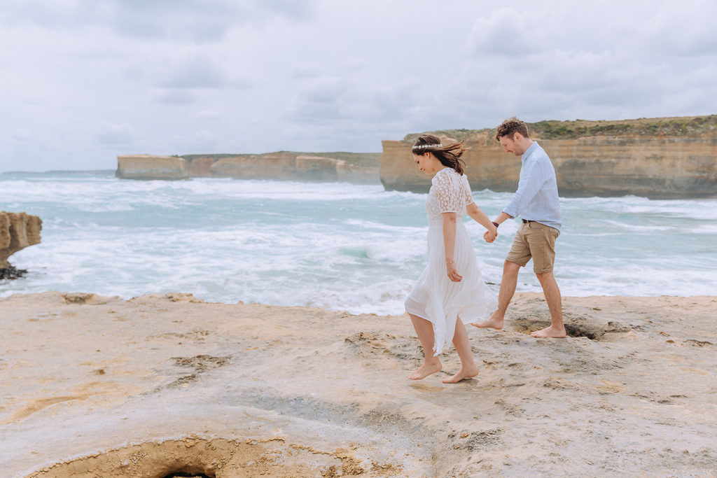 pre wedding photography  of couple walking on a cliff