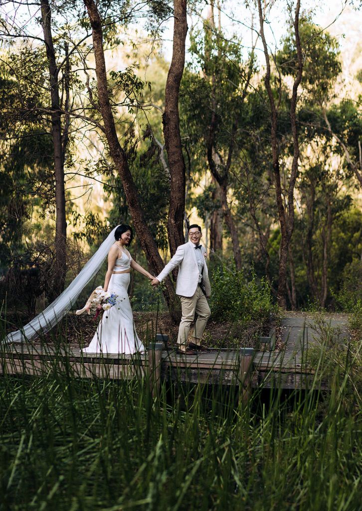 wedding couple on a bridge getting married in a forest
